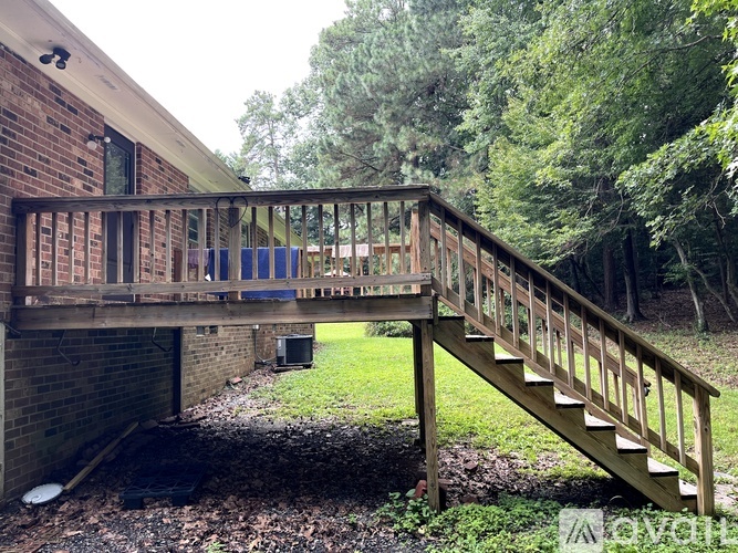 A wooden staircase leads up to a balcony.