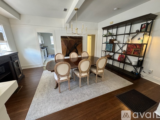 A dining room with a wooden table and chairs.