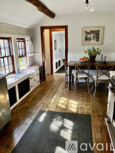 A kitchen with a table and chairs in the middle of the room.