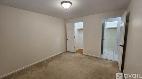 A room with a carpeted floor and a ceiling light.