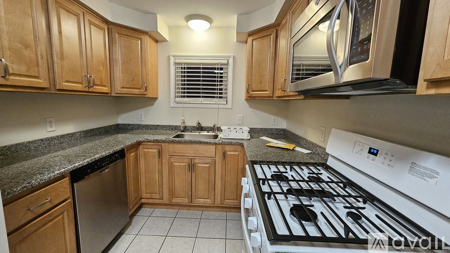 A kitchen with a stove top oven and a microwave.