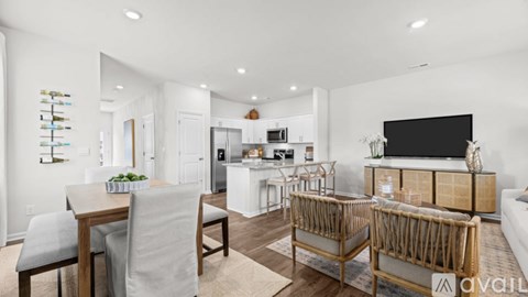 A modern living room with a dining table and chairs.