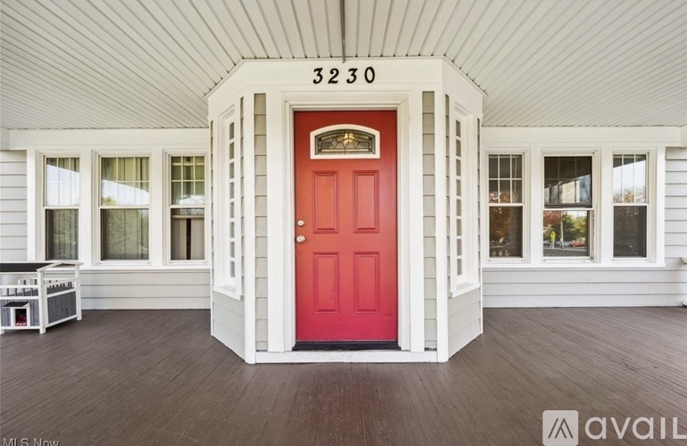 A red door with the number 3230 above it.