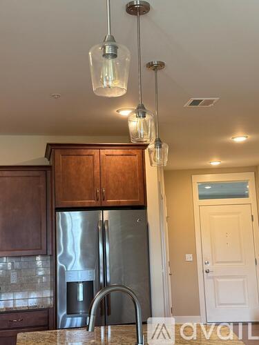 A kitchen with wooden cabinets and a granite countertop.