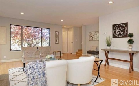 A living room with a white couch and a coffee table.