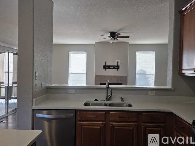 A kitchen with a stainless steel dishwasher and a white countertop.
