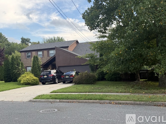 A black car is parked in front of a house.