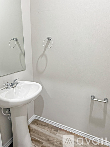 A white sink in a small bathroom.