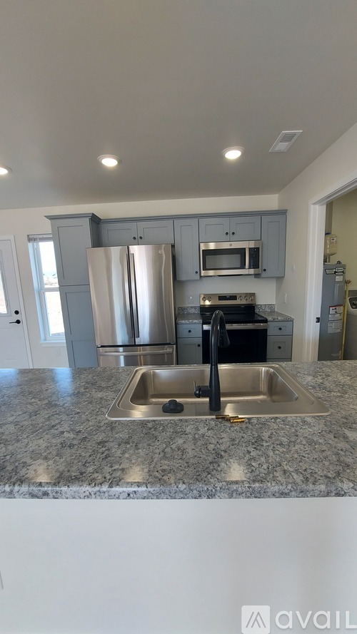 A kitchen with granite countertops and stainless steel appliances.