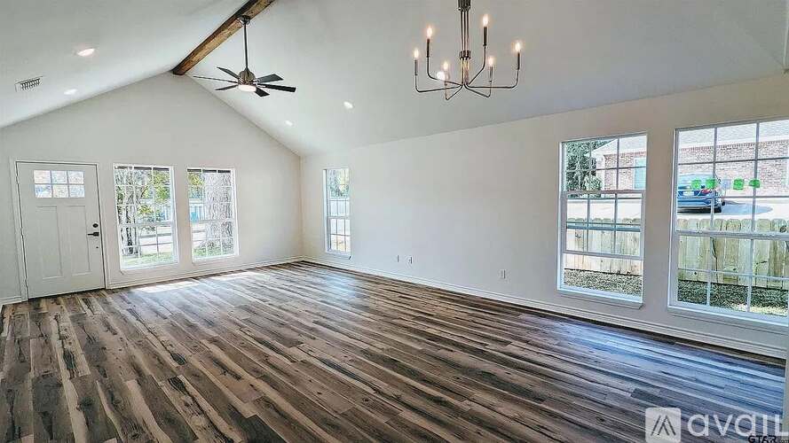 A room with wooden floors and a ceiling fan.