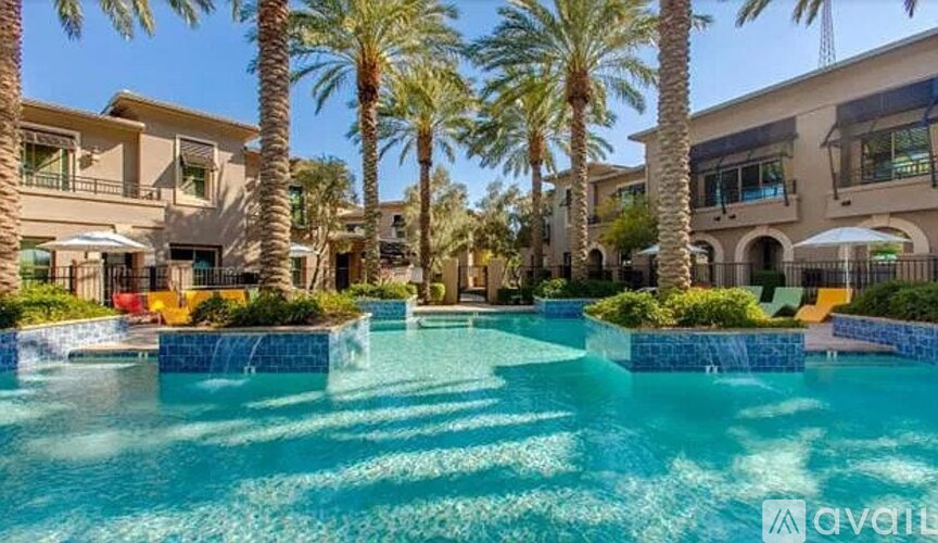 A pool surrounded by palm trees and buildings.