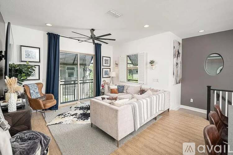 A modern bedroom with a large bed and a balcony.