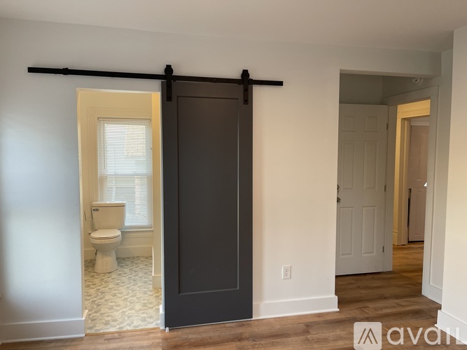 A bathroom with a toilet and a sliding door.