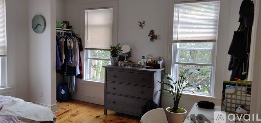 A bedroom with a dresser and a window.