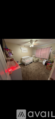 A baby room with a crib and a dresser.