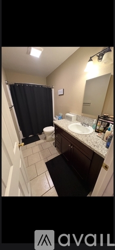 A bathroom with a sink, toilet, and shower.