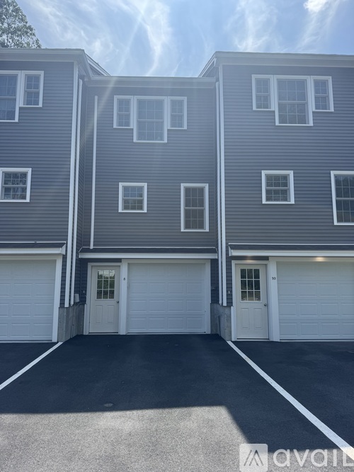 A two-story building with a garage door in front.