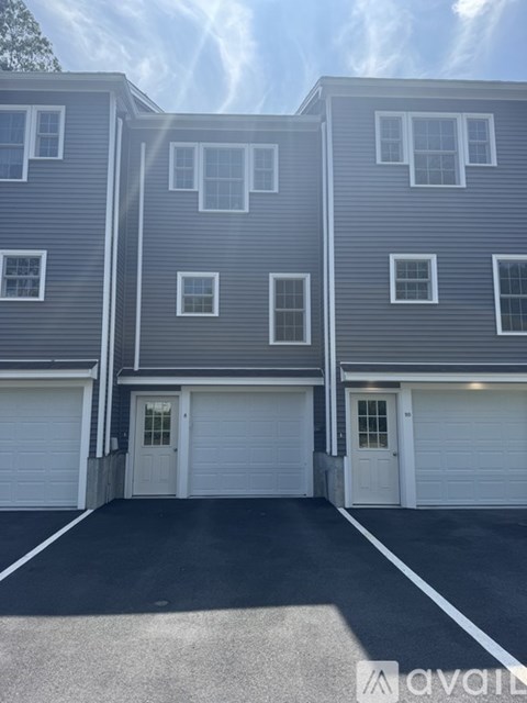 A two-story building with a garage door in front.