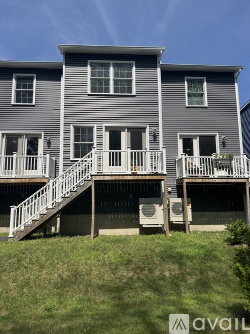 A two-story house with a balcony on the second floor.