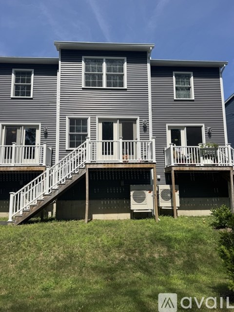 A two-story house with a balcony on the second floor.