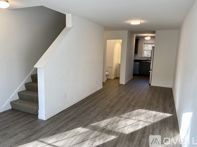 A living room with a staircase leading to the upper floor.