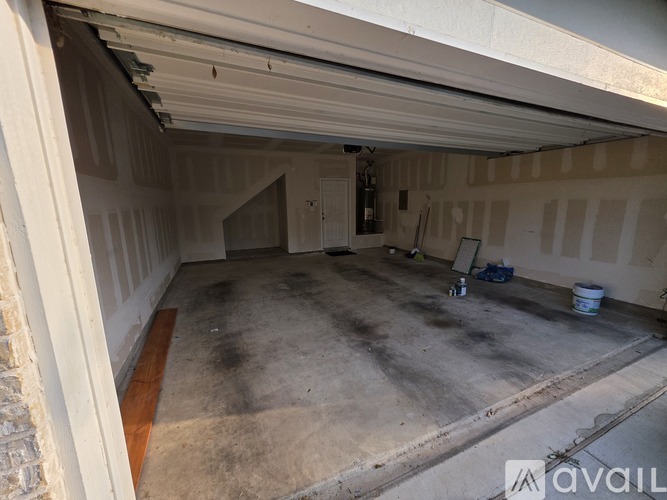 A spacious garage with a concrete floor and a white ceiling.