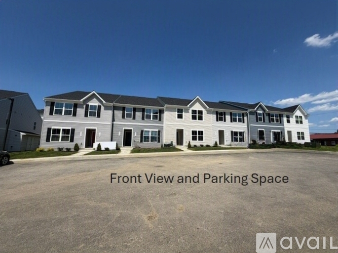A large building with a parking lot in front.