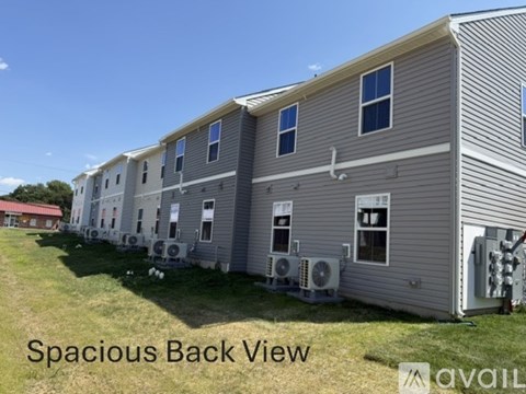 A row of houses with the back view and the caption "Spacious Back View" on the image.