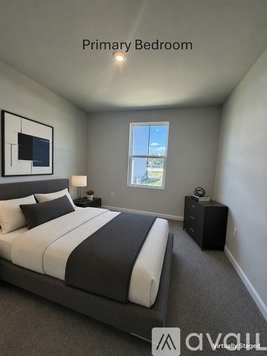 A bedroom with a large bed and a window.