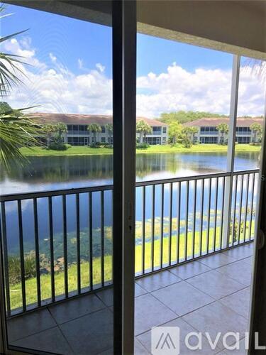 A balcony with a view of a lake and buildings.