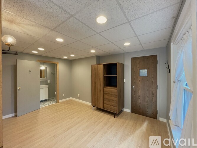 A spacious room with wooden floors and a large closet.