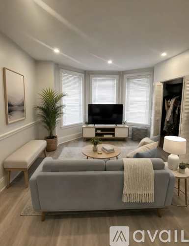 A living room with a grey sofa and a wooden coffee table.