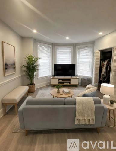 A living room with a grey sofa and a wooden coffee table.