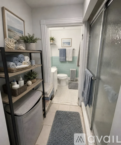A bathroom with a toilet, a shower, and a shelf with towels and plants.