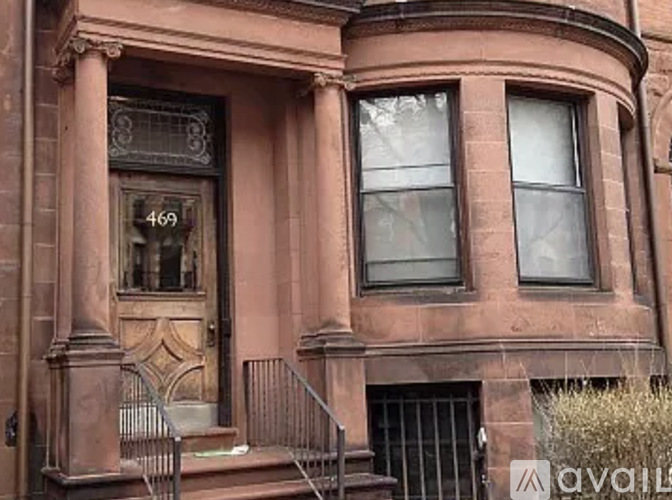 A brown building with the number 469 on it.