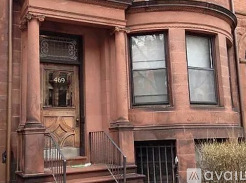 A brown building with the number 469 on it.