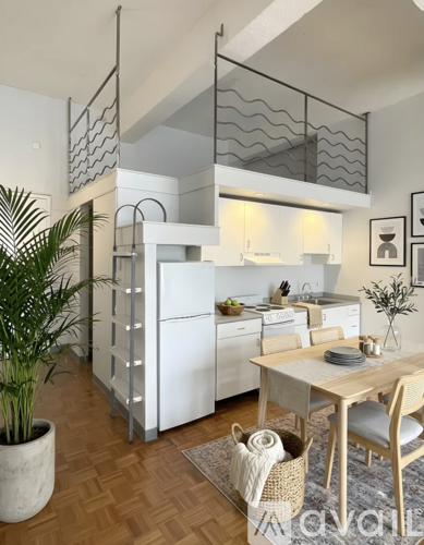 A modern kitchen with a dining table and chairs.