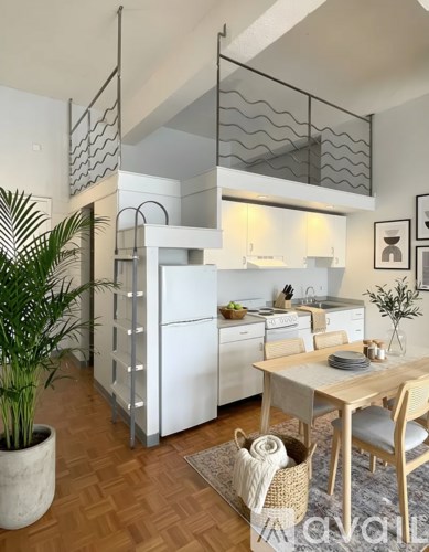 A modern kitchen with a dining table and chairs.