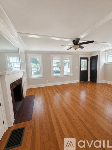 A room with wooden floors and a fireplace.