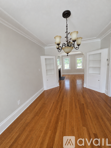 A room with wooden floors and a chandelier.