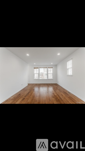 A room with wooden floors and white walls.