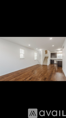 A room with wooden floors and white walls.