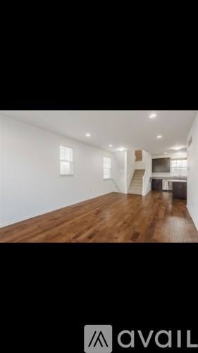A room with wooden floors and white walls.