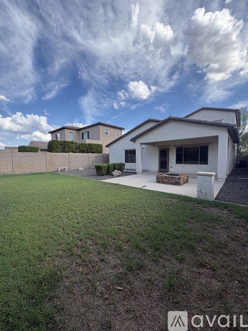 A modern house with a white exterior and a large front yard.