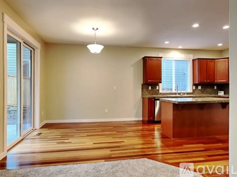 A kitchen with wooden floors and a center island.