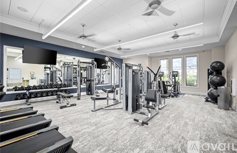 A well-equipped gym with various exercise machines and weights.