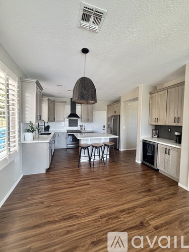 A kitchen with wooden floors and a dining table.
