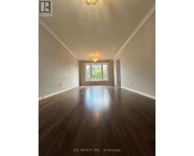 A room with wooden floors and a chandelier.