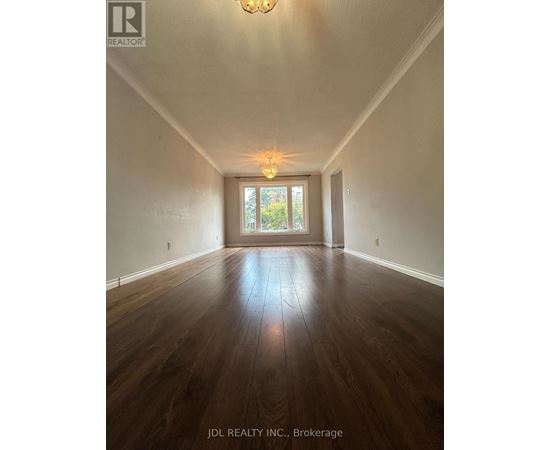 A room with wooden floors and a chandelier.