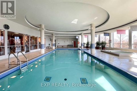 A large indoor swimming pool with a glass bottom.